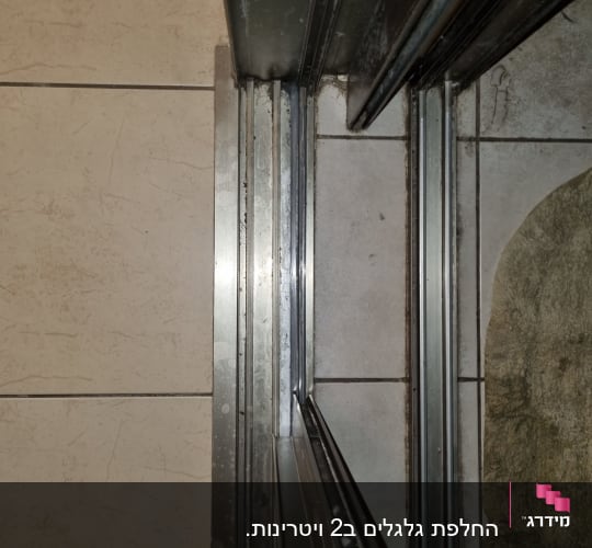מסילות מתכת לתריסים על רצפת אריחים